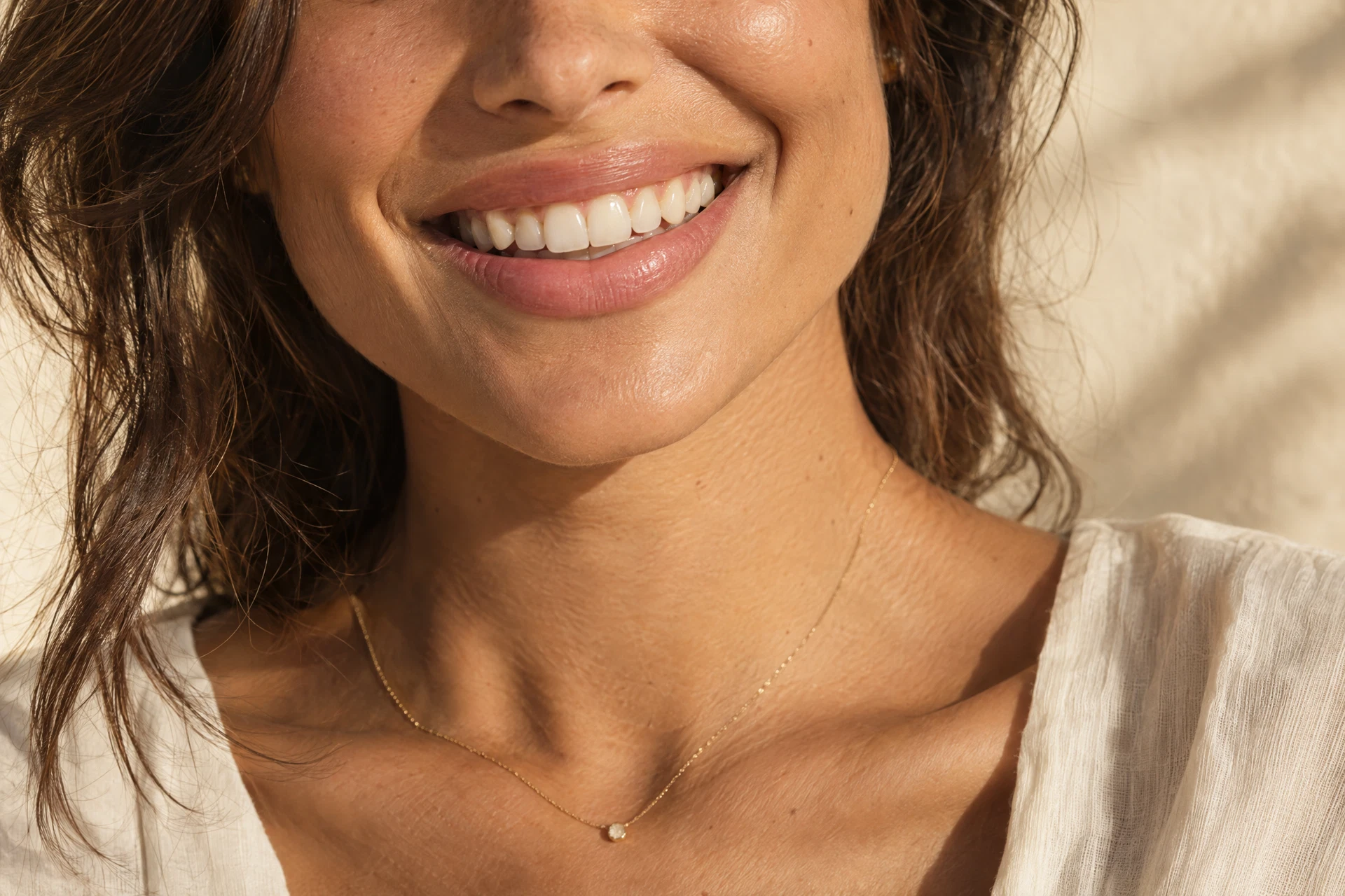 Editorial close-up of a warm, natural smile; not a clinical case